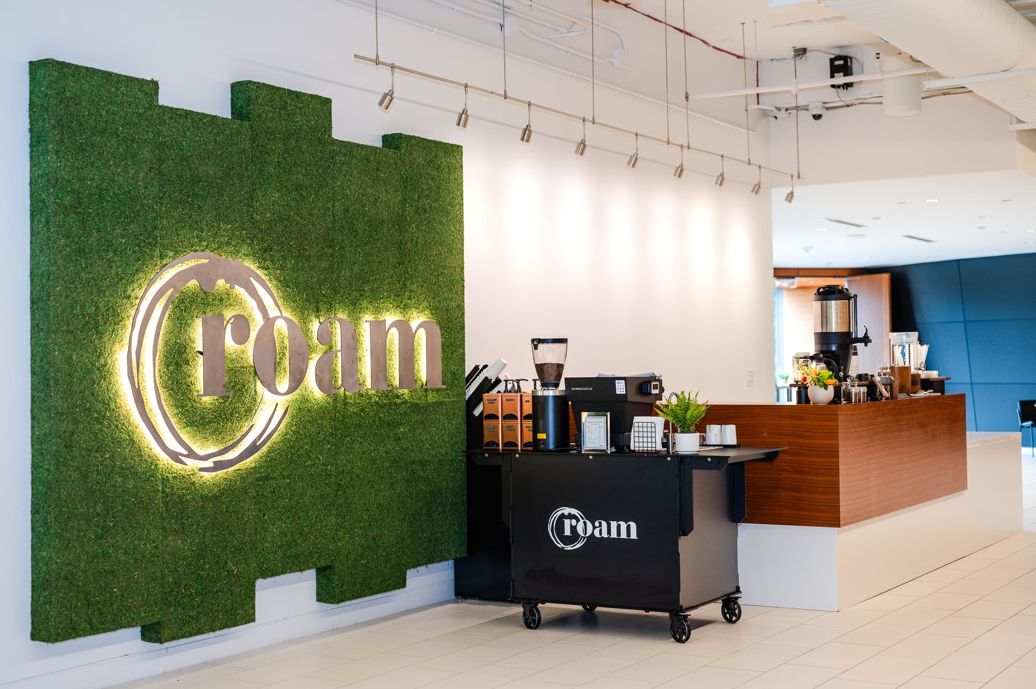 ROAM Greenville coworking lounge with warm lighting, leather seating, and modern décor